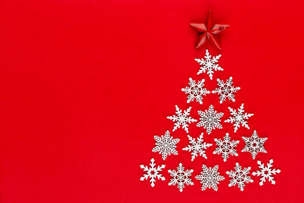 istock White snow flake decoration on red background. Flat lay, top view 1173559281