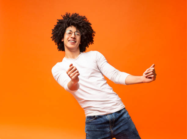 Awesome bushy guy dancing club moves on orange background