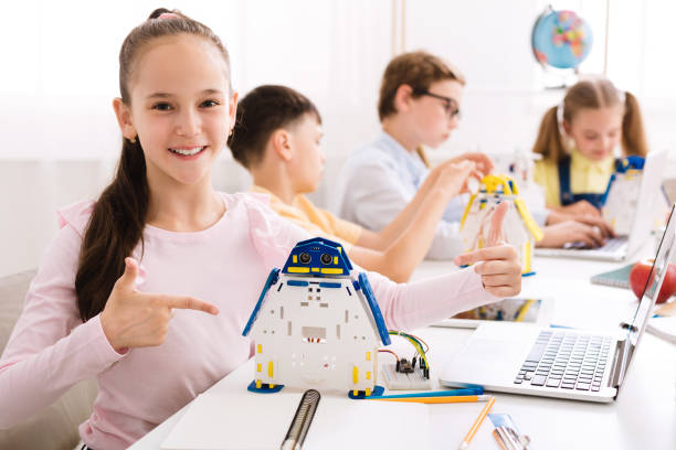istock Girl showing her robot, pointing finger on it 1173559519