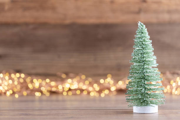 istock Colorful Christmas tree on wooden, bokeh background. 1173559795