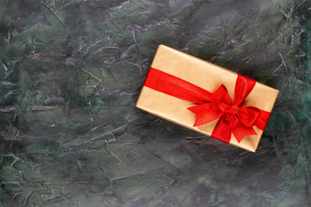 istock Christmas gift boxes with ribbons and tree on bokeh background. 1173560912