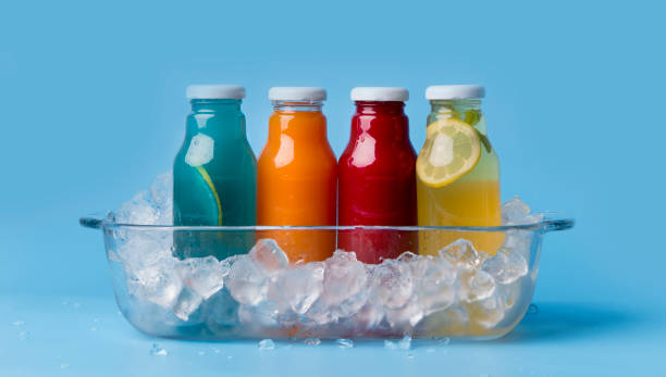 istock Different flavoured detox drinks in glass bottles on blue 1173563630