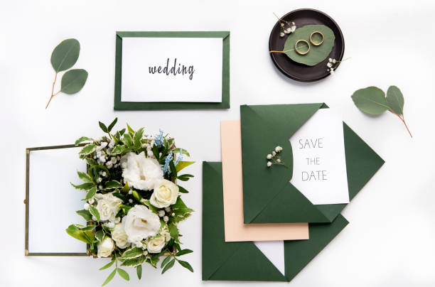 istock Craft green wedding envelopes with invitations on white 1173563661