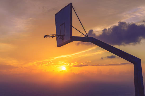 istock basketball basket against sunset sky 1173563953