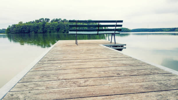 istock Boat launch on a calm lake overlooking islands - uckermark, germany 1173565106