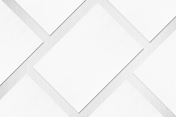 istock Close up of empty white rectangle poster or card mockups lying diagonally with soft shadow on neutral light grey textured background 1173565125