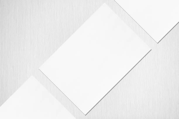 istock Close up of three empty white rectangle poster or card mockups lying diagonally 1173565127