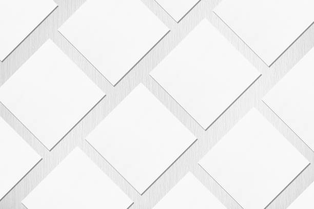 empty white square business card mockups lying diagonally on neutral light grey textured background