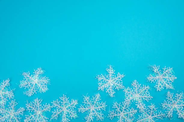 istock Creative Christmas layout. Snowflakes on blue background with copy space. 1173565305