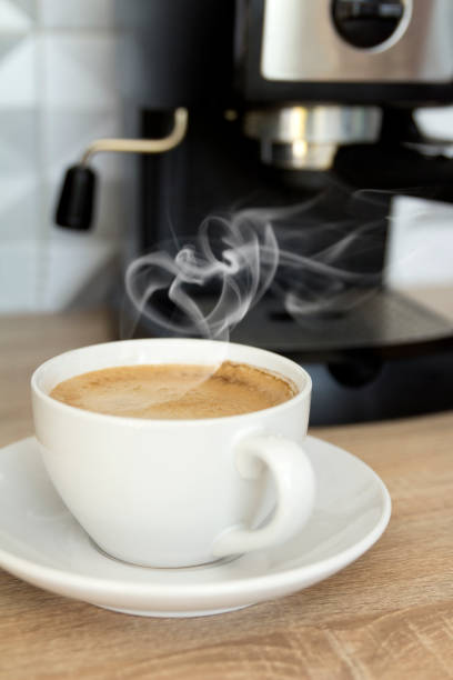 istock Coffee in white cup with coffee machine at the kitchen 1173565401