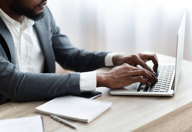 istock African American employee working on laptop in modern office 1173565470