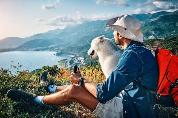 man his best friend taking a break from hiking