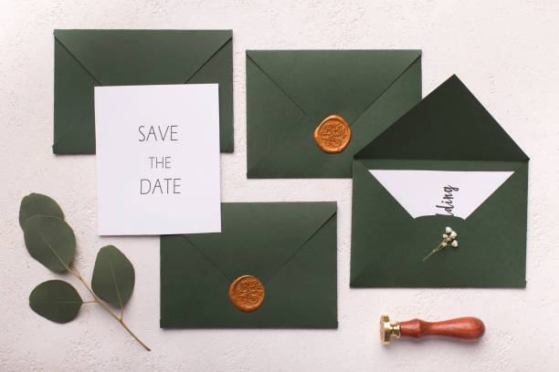 istock Green stylish envelopes with wedding postcards on white 1173567137