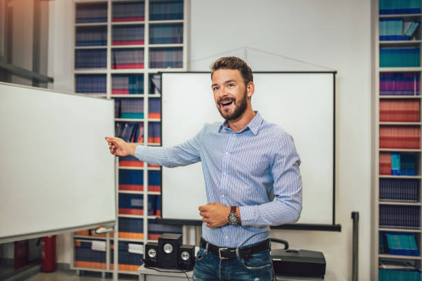 istock Smiling male coach giving presentation for audience in lecture hall 1173567917