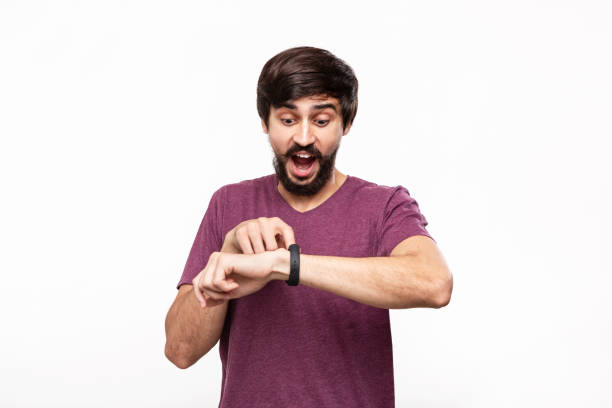 istock Excited brunet bearded man with moustaches checking notification with smart watches. Using modern technologies in everyday life. 1173569049