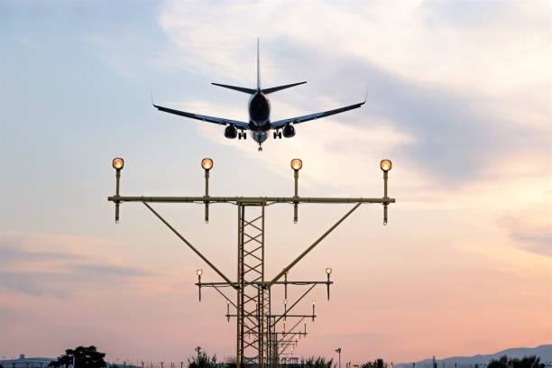 istock Aircraft during the approach procedure at sunset overflying the runway lights 1173569305