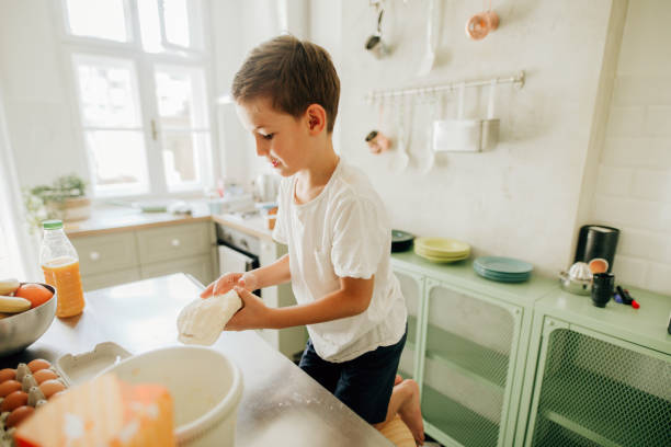 istock Little boy baking in the kitchen 1173570327