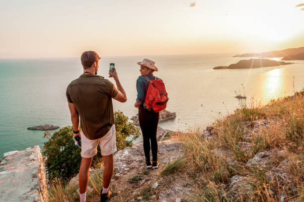 istock Young couple taking picture at hiking 1173571795