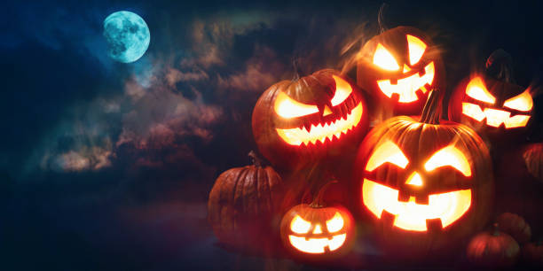 istock Halloween pumpkin head jack lantern with burning candles 1173573815