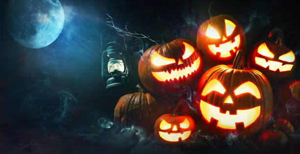 Halloween pumpkin head jack lantern with burning candles Halloween pumpkin head jack lantern with burning candles in scary deep night forest happy halloween pumpkin stock pictures, royalty-free photos & images