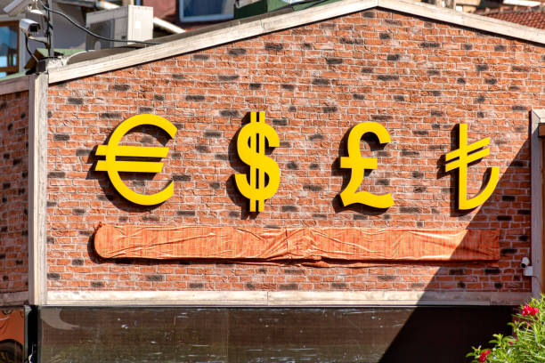 istock Currency Symbols on Brick Wall 1173574148