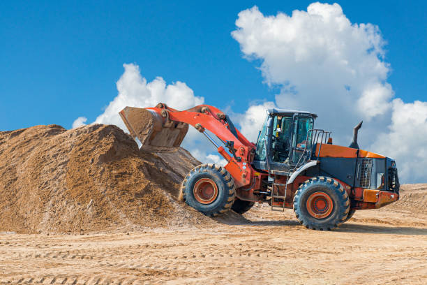 istock Backhoe loader or bulldozer - excavator with clipping path on a background with blue sky and clouds. work on construction site or sand pit 1173574280