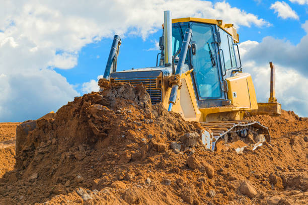 istock Crawler bulldozer - excavator with clipping path on a background with blue sky and clouds. work on construction site or sand pit 1173574294