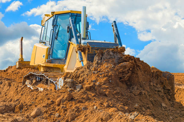 istock Crawler bulldozer - excavator with clipping path on a background with blue sky and clouds. work on construction site or sand pit 1173574336