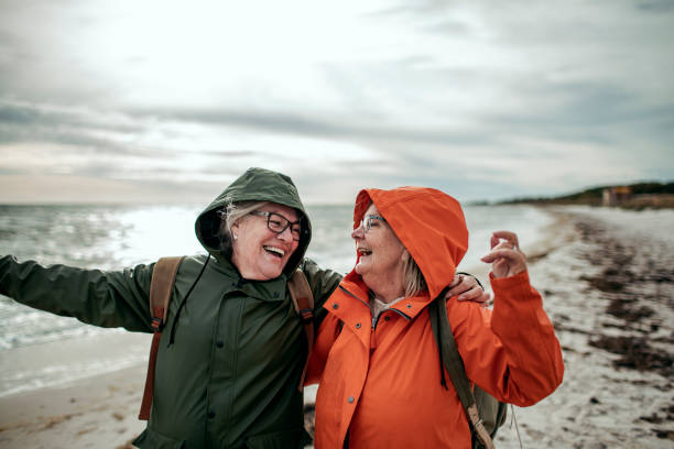 istock Seniors walking by the beach 1173575698