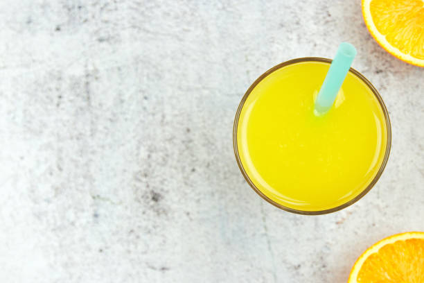 istock Cold fresh orange juice on a white concrete background. Top view, flat lay, copy space. citrus drink. 1173576018