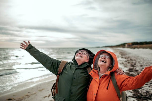 istock Seniors walking by the beach 1173576279
