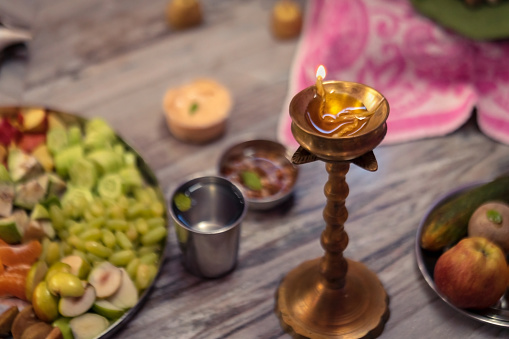 Diya oil lamp lit during durga puja or diwali. Background image for puja essentials on this festive season with space for text.