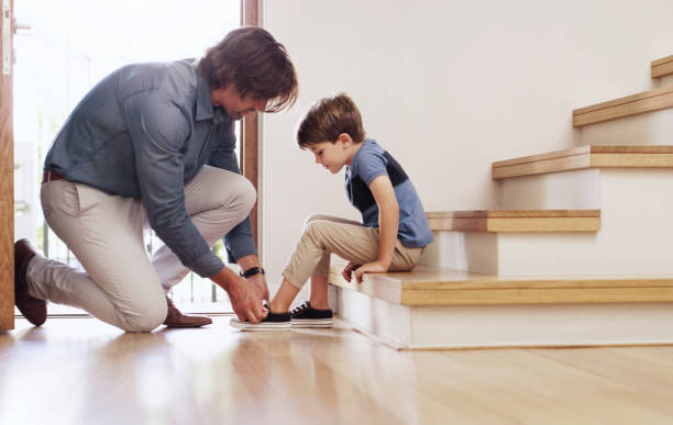 We're laced up and ready to go Full length shot of a father tying his young son's shoelaces at home child tied up stock pictures, royalty-free photos & images