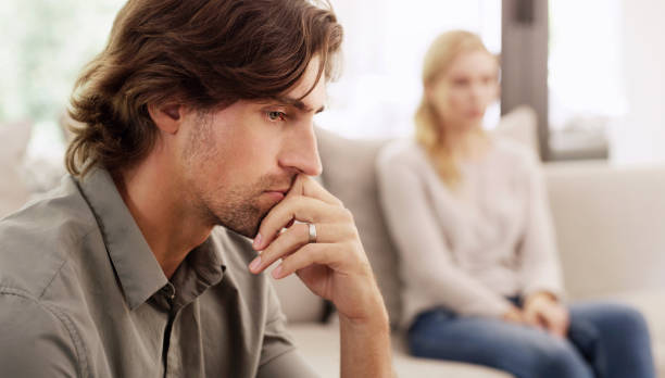 Things will never be the same again after this Shot of a handsome young man looking upset after having a disagreement with his wife at home never the same stock pictures, royalty-free photos & images