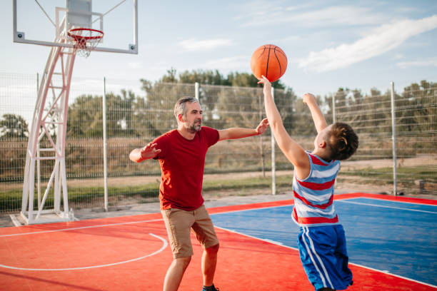 istock Father and son playing basketball 1173579735