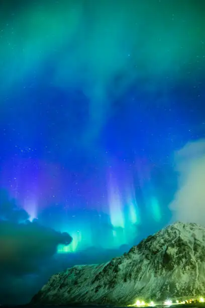 Photo of Amazing Picturesque Unique Nothern Lights Aurora Borealis Over Lofoten Islands in Nothern Part of Norway. Over the Polar Circle. Vertical Image Composition