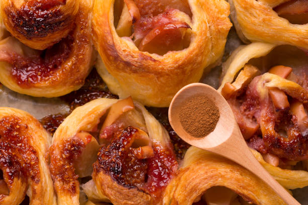 istock Cinnamon on buns with apples close-up. 1173581457