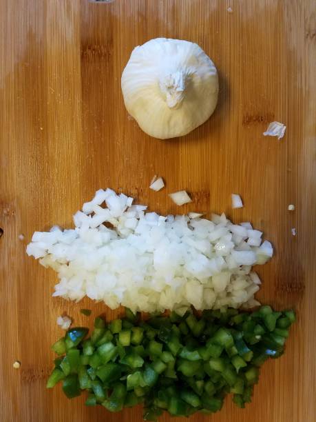 istock garlic and onion and green pepper on cutting board 1173582097