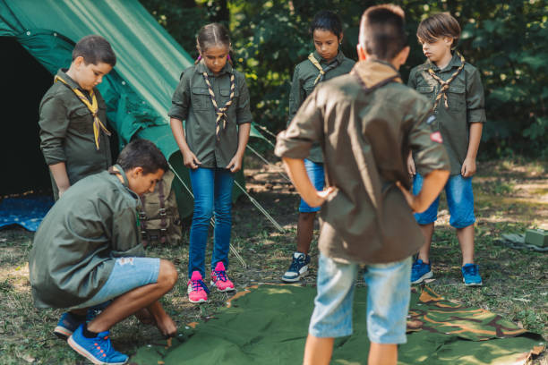istock Group Of Scouts Building A Tent 1173582584