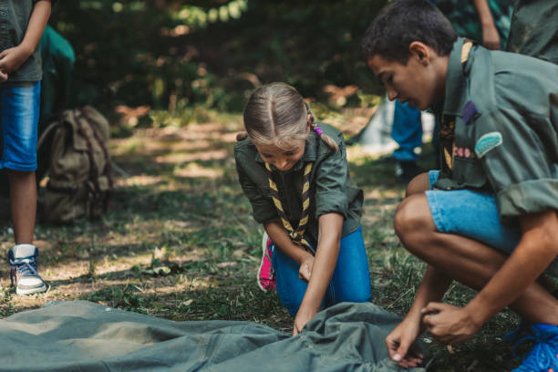 istock Group Of Scouts Building A Tent 1173582586