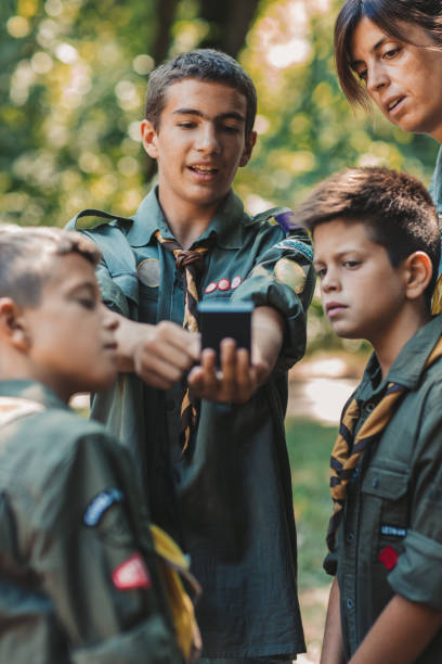 15 years old boy scout teaching boys and girls how to use compass - years 13 14 years teenager old imagens e fotografias de stock