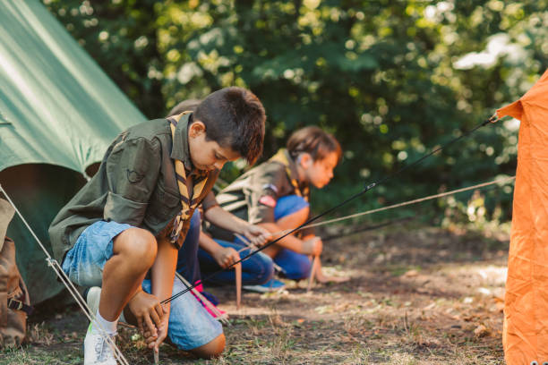 istock Group Of Scouts Building A Tent 1173583312