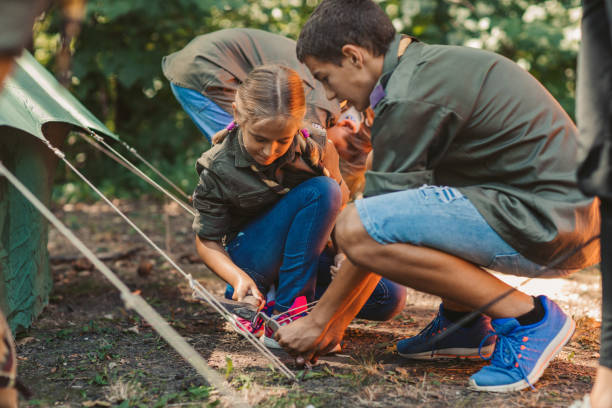 istock Group Of Scouts Building A Tent 1173583344
