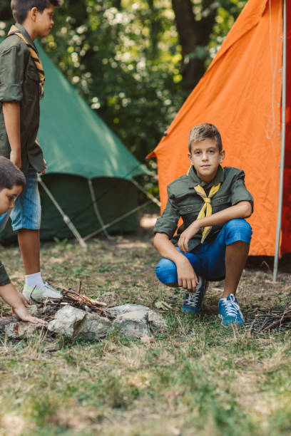 istock Group Of Scouts Roast Marshmallow Candies On Campfire In Forest 1173583359