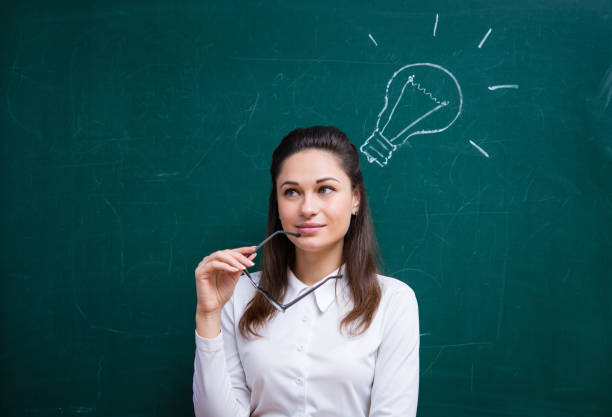istock young teacher comes up with an idea near the board 1173583908