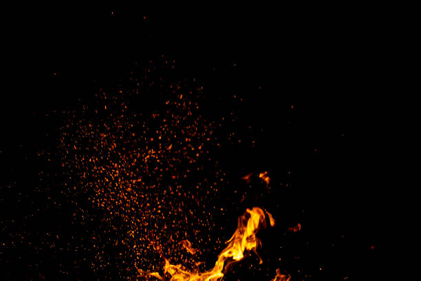 istock Burning red hot sparks fly from large fire in the night sky. Beautiful abstract background on the theme of fire, light and life. 1173584024