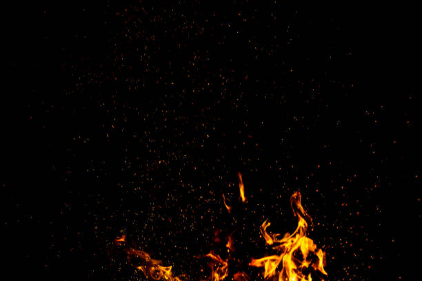 istock Burning red hot sparks fly from large fire in the night sky. Beautiful abstract background on the theme of fire, light and life. 1173584026