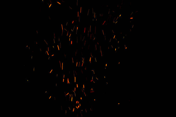 istock Burning red hot sparks fly from large fire in the night sky. Beautiful abstract background on the theme of fire, light and life. 1173584040