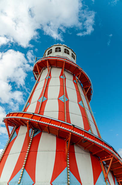 Clacton on sea's colourful helter skelter slide A traditional lighthouse helter skeltor on Clacton pier set againts a summer blue sky. clacton on sea stock pictures, royalty-free photos & images