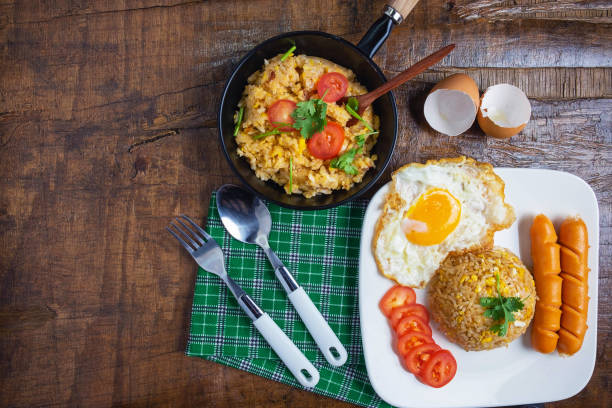 istock Cook American fried rice in a pan, served with fried eggs and sausages. 1173588886